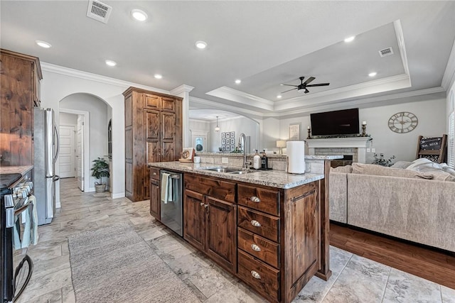 1208 Hickory St, Cave Springs, AR 72718 - kitchen with arched walkways, a ceiling fan, appliances with stainless steel finishes, open floor plan, and crown molding