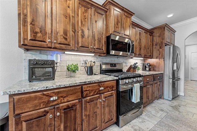 1208 Hickory St, Cave Springs, AR 72718 - kitchen featuring appliances with stainless steel finishes, ornamental molding, tasteful backsplash, and light stone countertops