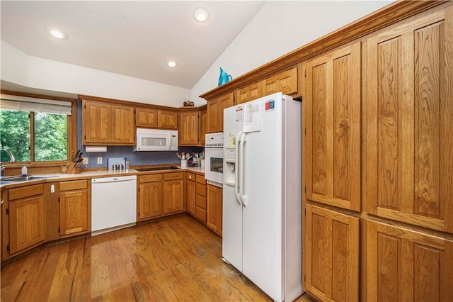 161 Hillcrest Rd, Eureka Springs, AR 72631 - kitchen with white appliances, vaulted ceiling, brown cabinets, light wood-type flooring, and recessed lighting