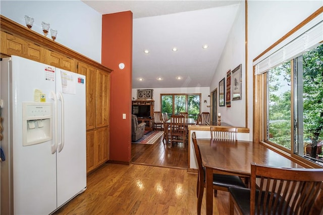 161 Hillcrest Rd, Eureka Springs, AR 72631 - dining space with healthy amount of natural light, wood finished floors, vaulted ceiling, recessed lighting, and a stone fireplace