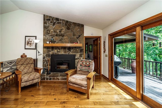 161 Hillcrest Rd, Eureka Springs, AR 72631 - living area with vaulted ceiling, plenty of natural light, light wood-type flooring, and a fireplace
