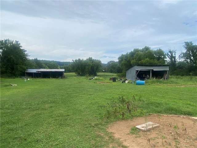 3218 Mulberry Wire Rd, Mulberry, AR 72947 - view of grassy yard with an outbuilding, an outdoor structure, and a carport