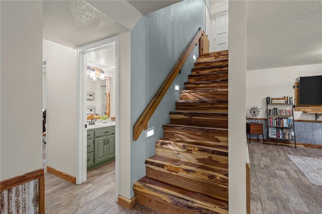 16590 Roughton Ln, Pea Ridge, AR 72751 - stairway with a textured ceiling and wood finished floors
