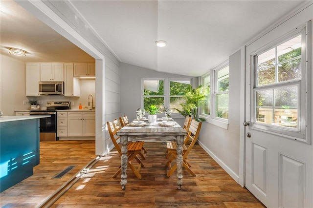2 Rochdale Dr, Bella Vista, AR 72714 - dining room featuring light wood-type flooring and lofted ceiling