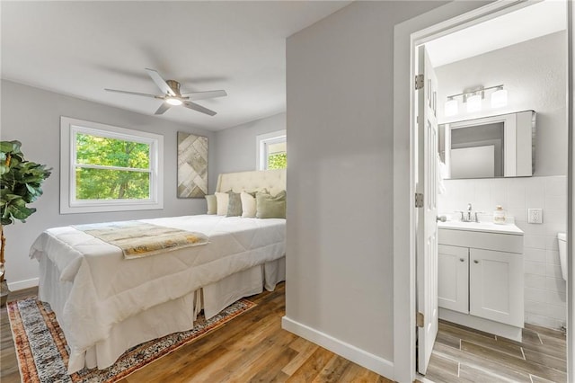 2 Rochdale Dr, Bella Vista, AR 72714 - bedroom with light wood finished floors, multiple windows, and connected bathroom