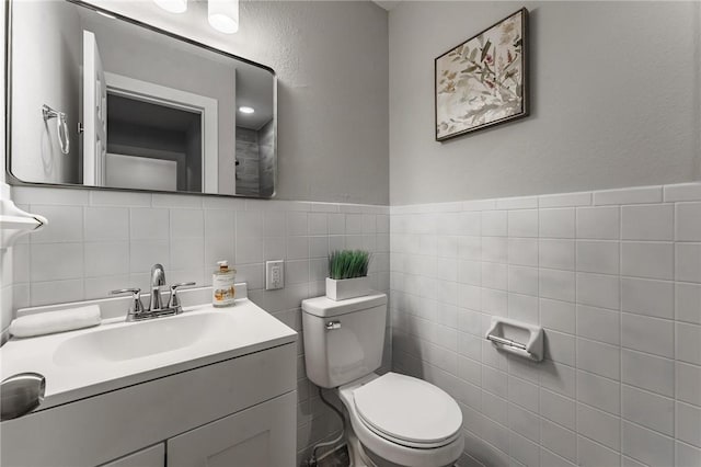 2 Rochdale Dr, Bella Vista, AR 72714 - half bath featuring tile walls, vanity, and a wainscoted wall