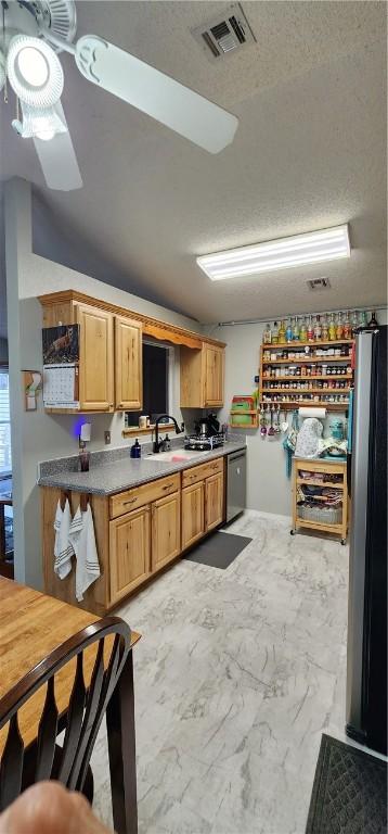 1210 Spring St, Bentonville, AR 72712 - kitchen featuring light marble finish flooring, a ceiling fan, a textured ceiling, and stainless steel dishwasher