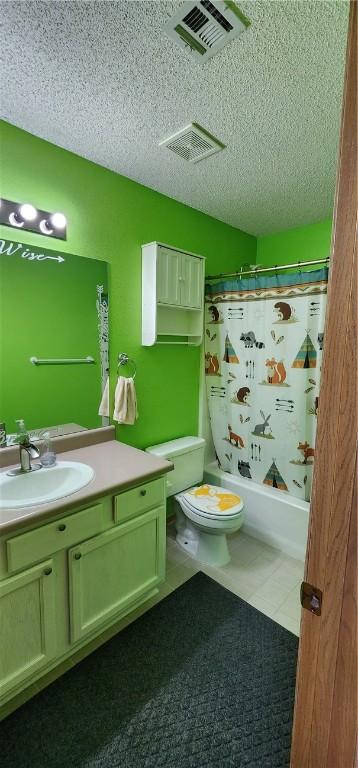 1210 Spring St, Bentonville, AR 72712 - full bathroom with a textured ceiling, vanity, tile patterned flooring, and shower / bath combo with shower curtain