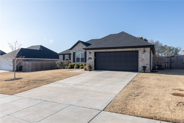 1355 NE Pershing St, Fayetteville, AR 72704 - view of front of property featuring an attached garage, brick siding, concrete driveway, and a shingled roof