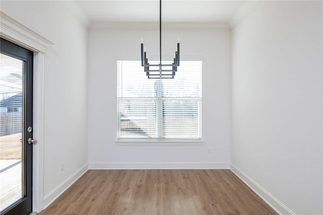 1355 NE Pershing St, Fayetteville, AR 72704 - unfurnished dining area with a chandelier, healthy amount of natural light, wood finished floors, and ornamental molding
