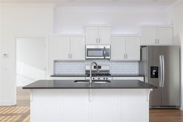 1355 NE Pershing St, Fayetteville, AR 72704 - kitchen with stainless steel appliances, dark countertops, crown molding, a center island with sink, and backsplash