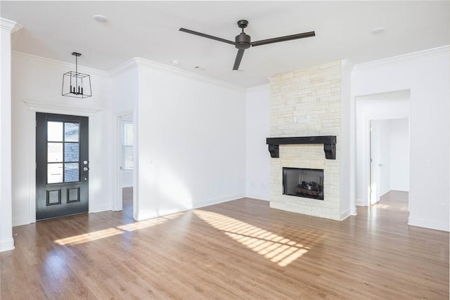 1355 NE Pershing St, Fayetteville, AR 72704 - unfurnished living room with wood finished floors, a ceiling fan, a fireplace, and crown molding