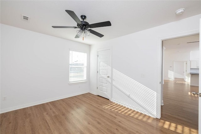 1355 NE Pershing St, Fayetteville, AR 72704 - unfurnished room featuring wood finished floors, a ceiling fan, and a smoke detector
