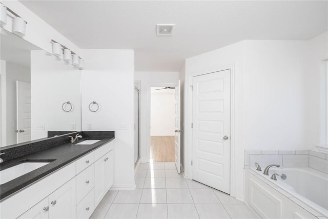 1355 NE Pershing St, Fayetteville, AR 72704 - full bath with double vanity, a bath, a shower stall, and tile patterned flooring