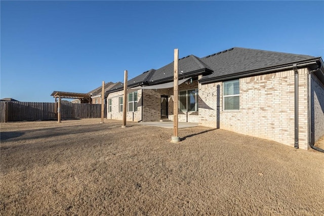 1355 NE Pershing St, Fayetteville, AR 72704 - back of house with brick siding, a patio, and a shingled roof