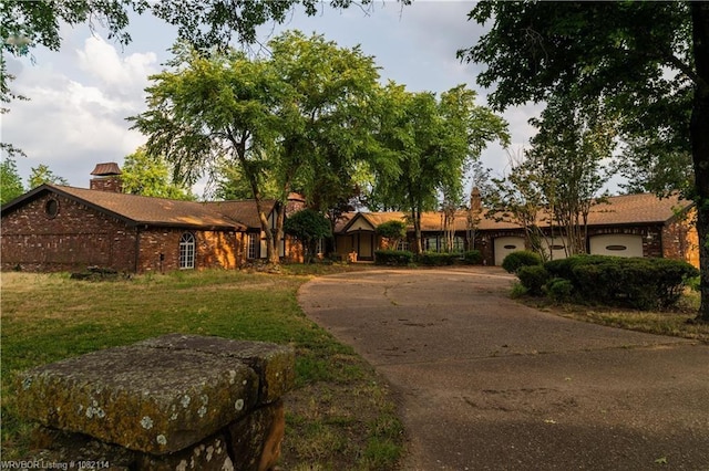 3655 Beach Way, Van Buren, AR 72956 - ranch-style house with concrete driveway, a garage, a front yard, brick siding, and a chimney