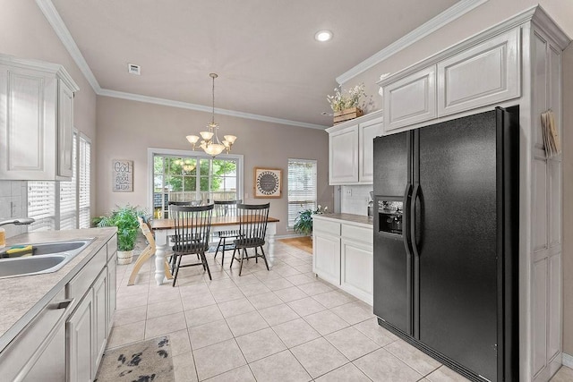 1409 S Breckenridge Loop, Rogers, AR 72756 - kitchen with black refrigerator with ice dispenser, light countertops, a chandelier, light tile patterned flooring, and crown molding