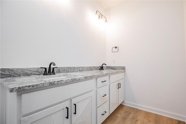 7 Consett Ln, Bella Vista, AR 72714 - bathroom featuring wood finished floors and double vanity