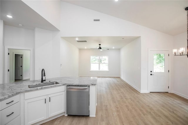 7 Consett Ln, Bella Vista, AR 72714 - kitchen featuring stainless steel dishwasher, lofted ceiling, plenty of natural light, white cabinetry, and light wood-style flooring