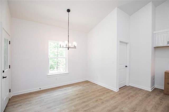 7 Consett Ln, Bella Vista, AR 72714 - unfurnished dining area featuring a chandelier, light wood-style flooring, and lofted ceiling
