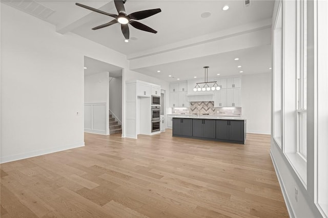 8607 W Feathered Nest Run, Bentonville, AR 72713 - unfurnished living room with ceiling fan, stairs, recessed lighting, and light wood-type flooring