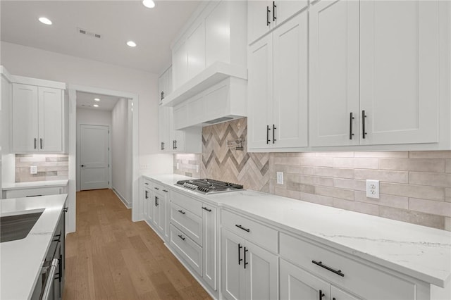 8607 W Feathered Nest Run, Bentonville, AR 72713 - kitchen featuring stainless steel gas cooktop, white cabinets, backsplash, and recessed lighting