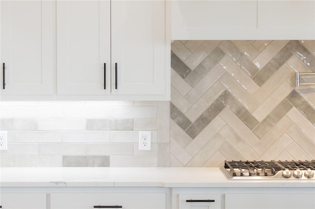 8607 W Feathered Nest Run, Bentonville, AR 72713 - kitchen with light countertops, decorative backsplash, white cabinetry, and stainless steel gas stovetop