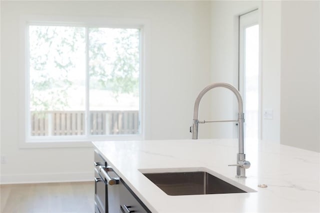 8607 W Feathered Nest Run, Bentonville, AR 72713 - kitchen featuring a sink and light stone counters
