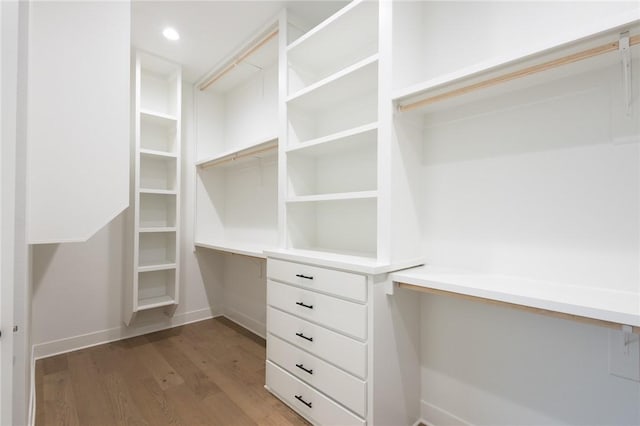 8607 W Feathered Nest Run, Bentonville, AR 72713 - walk in closet with built in desk and wood finished floors