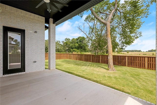 8607 W Feathered Nest Run, Bentonville, AR 72713 - fenced backyard with ceiling fan and a patio
