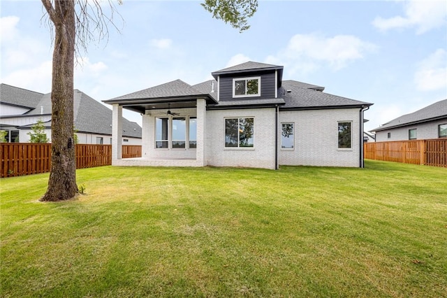 8607 W Feathered Nest Run, Bentonville, AR 72713 - back of house with a ceiling fan, a fenced backyard, roof with shingles, and brick siding