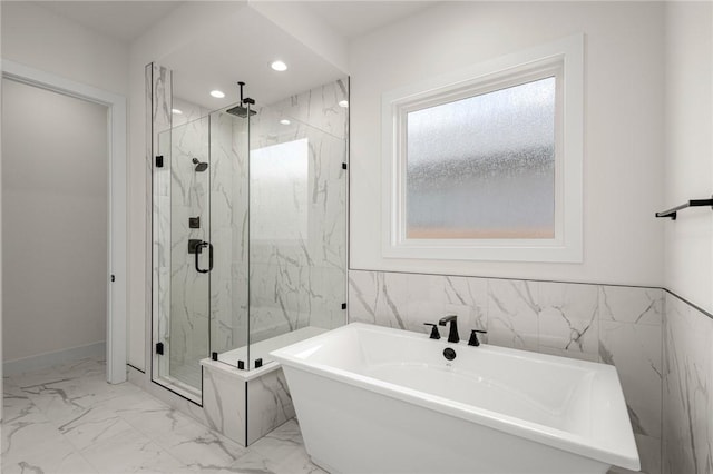 8607 W Feathered Nest Run, Bentonville, AR 72713 - bathroom with a freestanding tub, a marble finish shower, marble look tile flooring, and recessed lighting