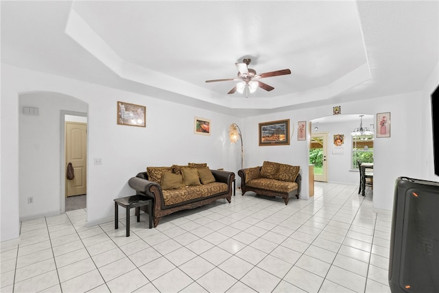 2302 12th Pl, Rogers, AR 72758 - living area featuring arched walkways, a tray ceiling, ceiling fan, and light tile patterned floors