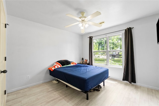 2302 12th Pl, Rogers, AR 72758 - bedroom with light wood-style flooring and ceiling fan
