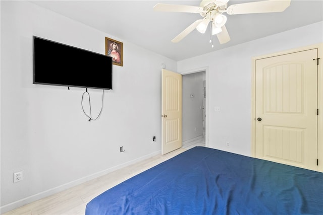 2302 12th Pl, Rogers, AR 72758 - unfurnished bedroom with wood finished floors and ceiling fan