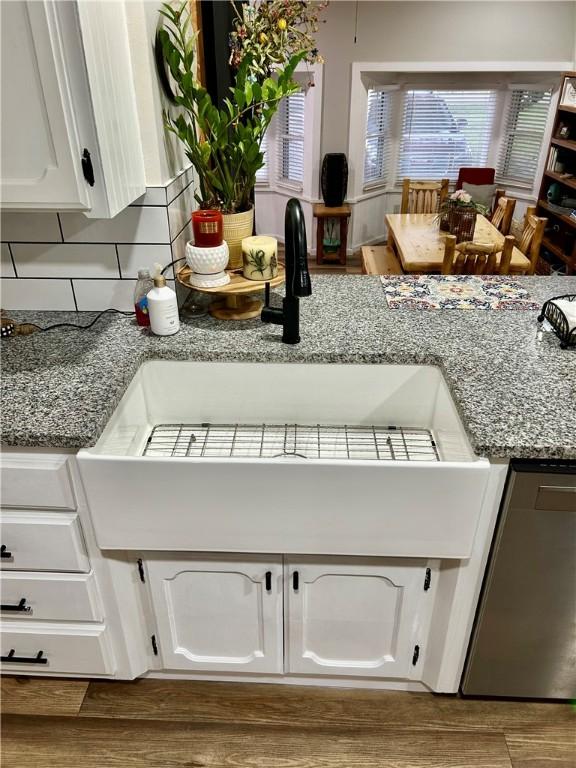 3383 Sr 164 E, Dover, AR 72837 - kitchen with white cabinetry, stainless steel dishwasher, and backsplash