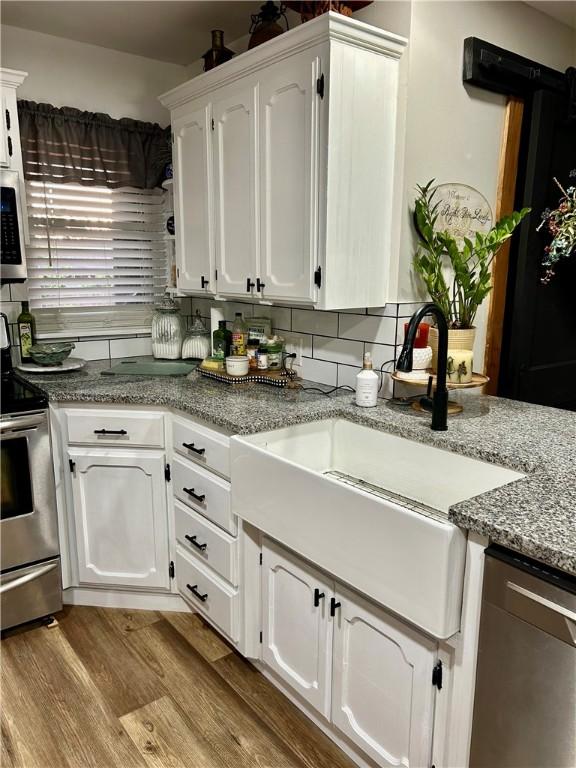 3383 Sr 164 E, Dover, AR 72837 - kitchen featuring stainless steel appliances, white cabinets, wood finished floors, backsplash, and light stone countertops