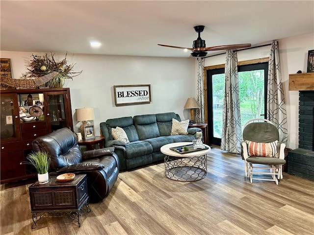 3383 Sr 164 E, Dover, AR 72837 - living room with a ceiling fan, wood finished floors, and a brick fireplace