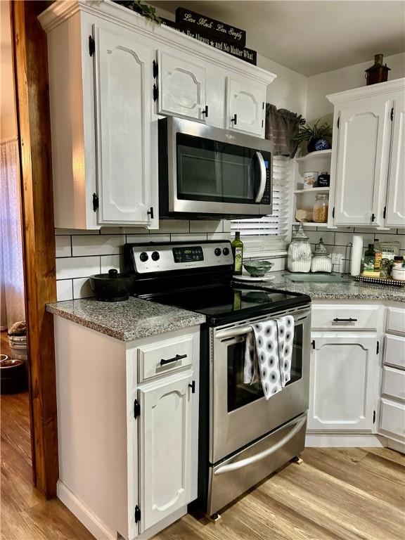 3383 Sr 164 E, Dover, AR 72837 - kitchen featuring stainless steel appliances, white cabinets, and light wood finished floors