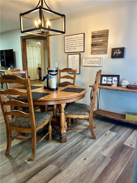 3383 Sr 164 E, Dover, AR 72837 - dining area featuring a chandelier and wood finished floors