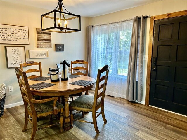 3383 Sr 164 E, Dover, AR 72837 - dining room featuring wood finished floors, healthy amount of natural light, and a chandelier
