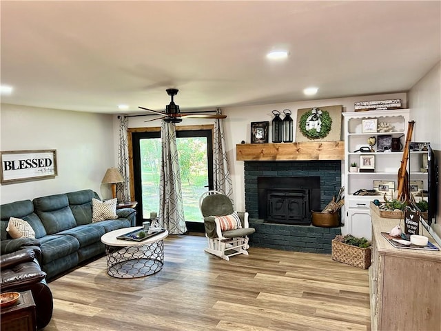 3383 Sr 164 E, Dover, AR 72837 - living area with light wood-style floors, a ceiling fan, a fireplace, and recessed lighting