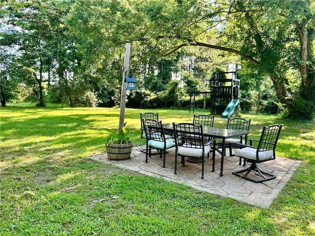 3383 Sr 164 E, Dover, AR 72837 - view of grassy yard with a playground, a patio area, outdoor dining area, and view of wooded area