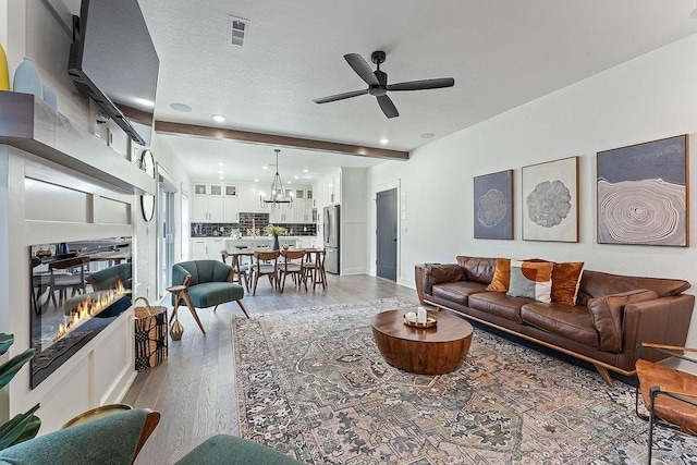 103 NW Ozark Way, Bentonville, AR 72712 - living area with light wood-type flooring, a chandelier, ceiling fan, and recessed lighting