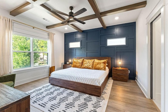 103 NW Ozark Way, Bentonville, AR 72712 - bedroom featuring beamed ceiling, light wood finished floors, coffered ceiling, recessed lighting, and a decorative wall