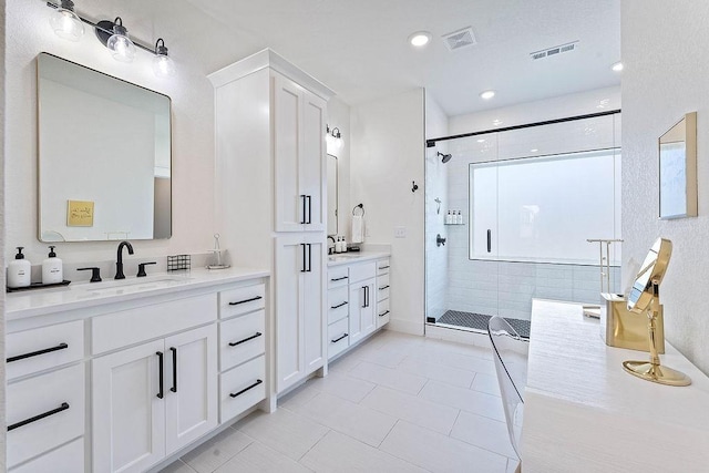 103 NW Ozark Way, Bentonville, AR 72712 - bathroom featuring a shower stall, two vanities, tile patterned flooring, and recessed lighting