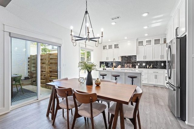 103 NW Ozark Way, Bentonville, AR 72712 - dining area featuring light wood-type flooring, a chandelier, and recessed lighting