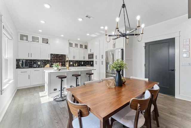 103 NW Ozark Way, Bentonville, AR 72712 - dining room with light wood-style floors, a chandelier, and recessed lighting