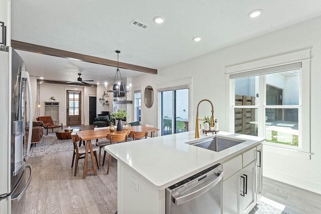 103 NW Ozark Way, Bentonville, AR 72712 - kitchen featuring appliances with stainless steel finishes, light wood-style floors, open floor plan, recessed lighting, and white cabinets
