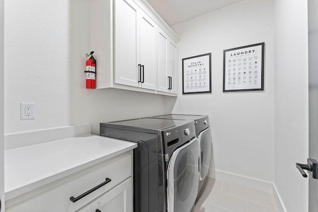 103 NW Ozark Way, Bentonville, AR 72712 - laundry room with cabinet space, washing machine and clothes dryer, and light tile patterned floors